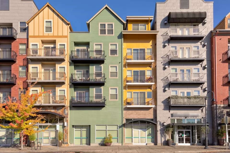 Colorful five-story condo buildings with retail on ground floor in Gresham, Oregon.